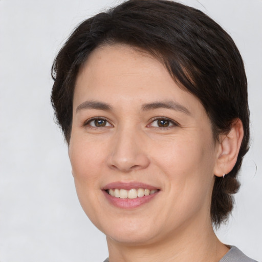 Joyful white young-adult female with medium  brown hair and brown eyes