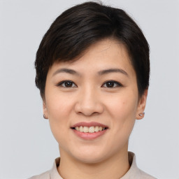 Joyful asian young-adult female with short  brown hair and brown eyes