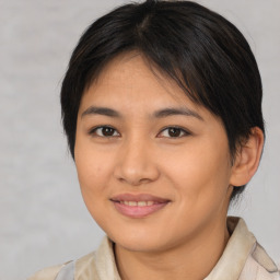 Joyful asian young-adult female with medium  brown hair and brown eyes