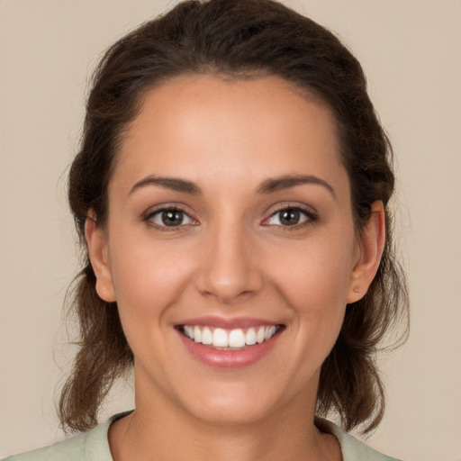 Joyful white young-adult female with long  brown hair and brown eyes