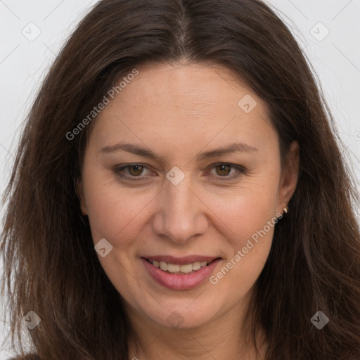 Joyful white adult female with long  brown hair and brown eyes