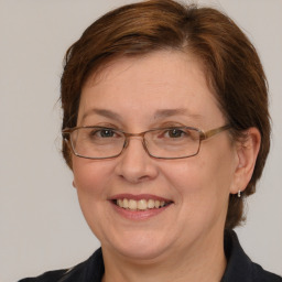 Joyful white adult female with medium  brown hair and grey eyes