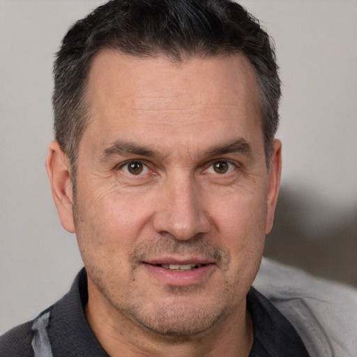 Joyful white adult male with short  brown hair and brown eyes