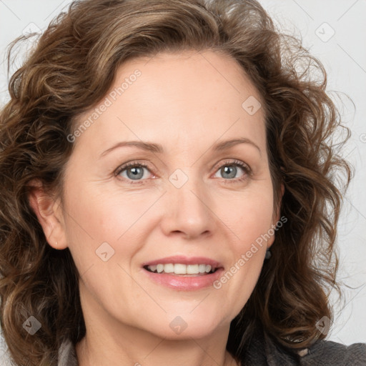 Joyful white adult female with medium  brown hair and green eyes