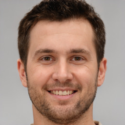 Joyful white young-adult male with short  brown hair and brown eyes