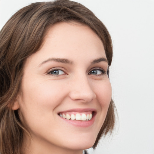 Joyful white young-adult female with medium  brown hair and green eyes