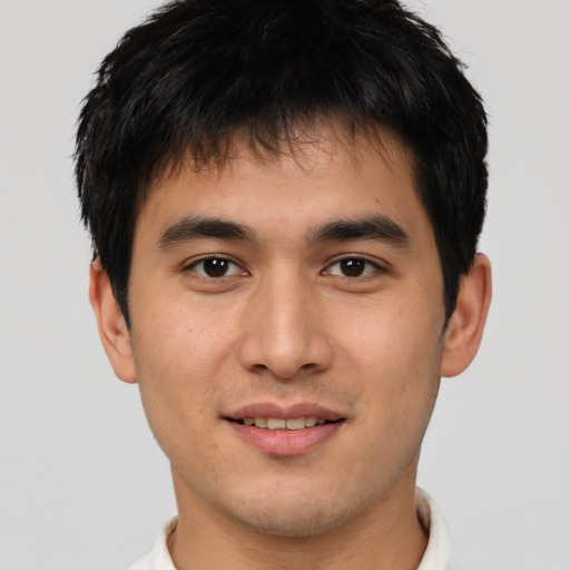 Joyful asian young-adult male with short  brown hair and brown eyes