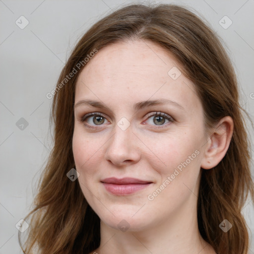 Joyful white young-adult female with long  brown hair and blue eyes