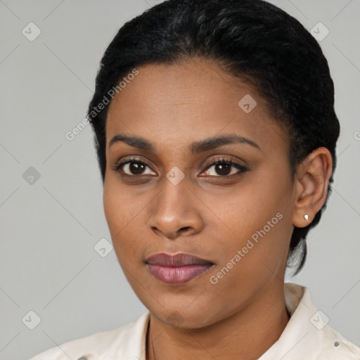 Joyful black young-adult female with short  black hair and brown eyes