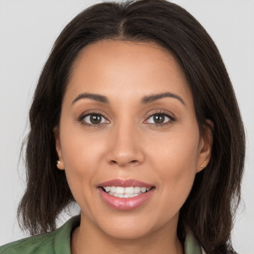 Joyful white young-adult female with long  brown hair and brown eyes