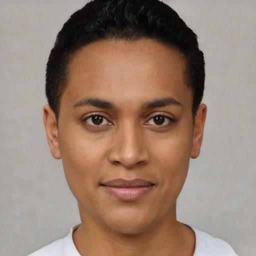 Joyful latino young-adult female with short  black hair and brown eyes