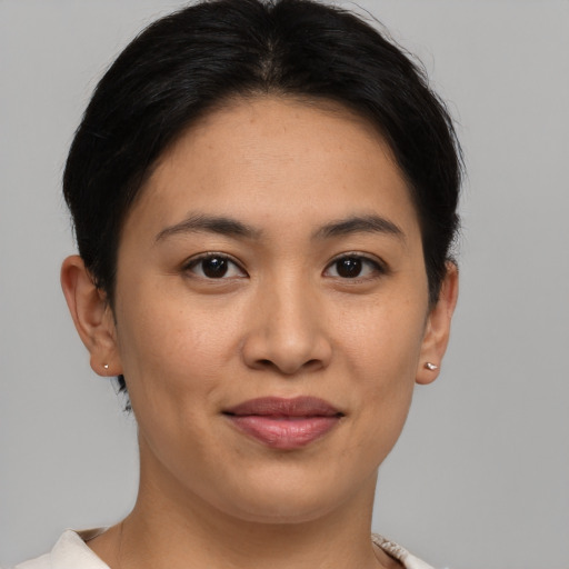 Joyful asian young-adult female with short  brown hair and brown eyes