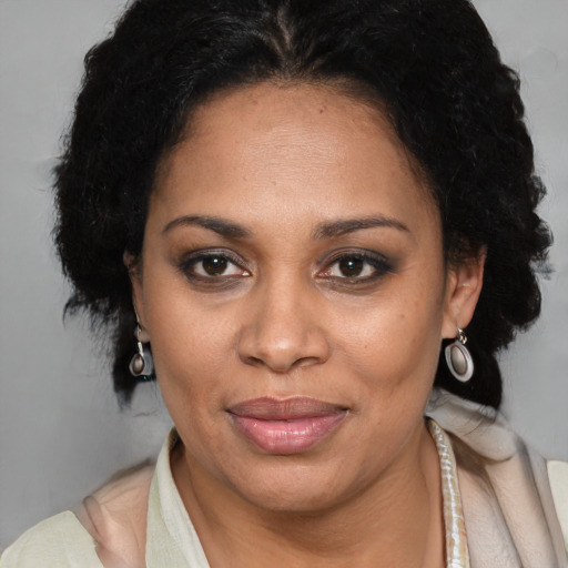 Joyful latino adult female with short  brown hair and brown eyes