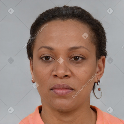 Joyful black adult female with short  brown hair and brown eyes