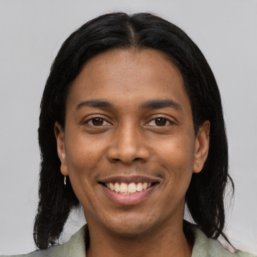 Joyful black young-adult female with medium  black hair and brown eyes