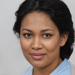 Joyful black young-adult female with medium  brown hair and brown eyes