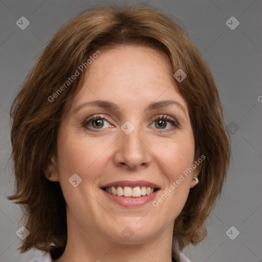 Joyful white adult female with medium  brown hair and green eyes