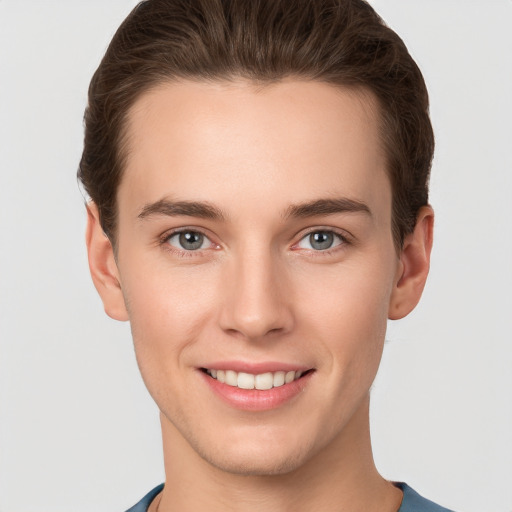 Joyful white young-adult female with short  brown hair and grey eyes