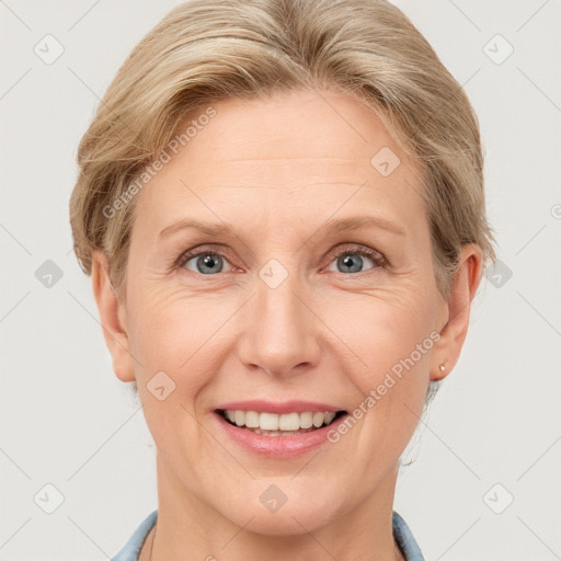 Joyful white adult female with short  brown hair and grey eyes