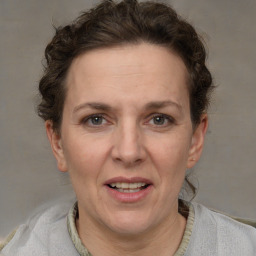 Joyful white adult female with short  brown hair and grey eyes