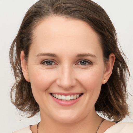 Joyful white young-adult female with medium  brown hair and brown eyes