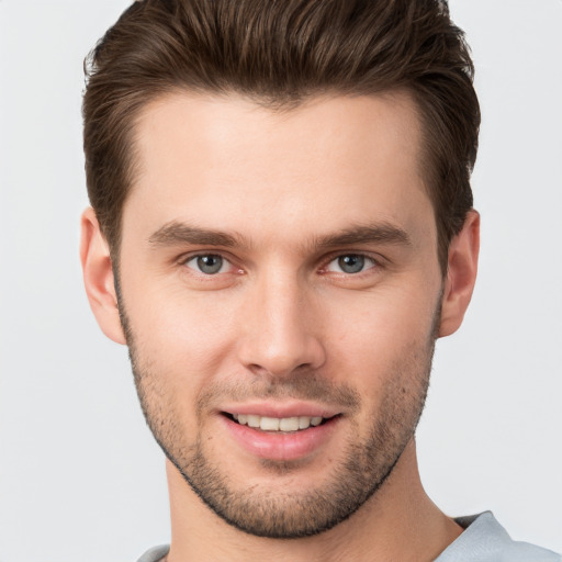 Joyful white young-adult male with short  brown hair and brown eyes