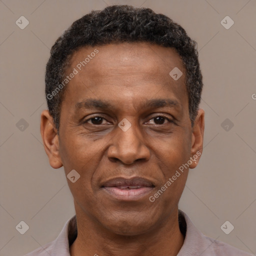 Joyful black adult male with short  black hair and brown eyes