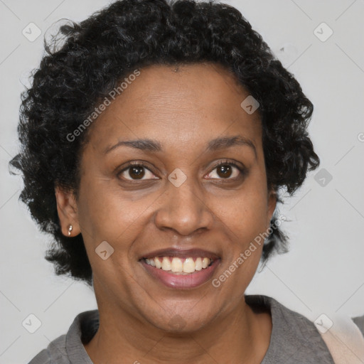 Joyful black adult female with short  brown hair and brown eyes
