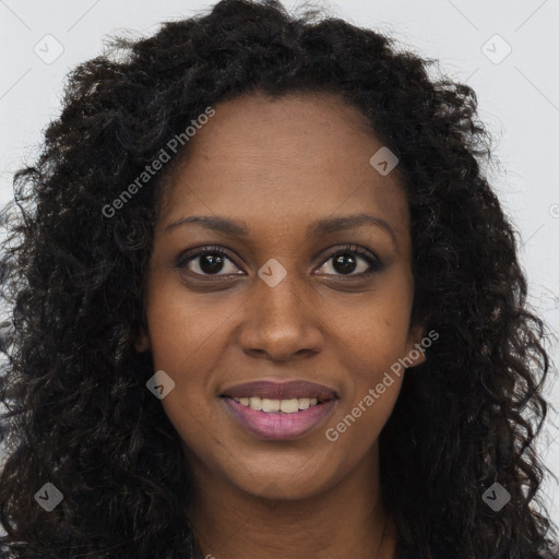 Joyful black young-adult female with long  brown hair and brown eyes