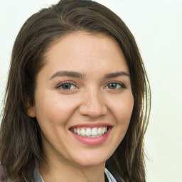 Joyful white young-adult female with long  brown hair and green eyes