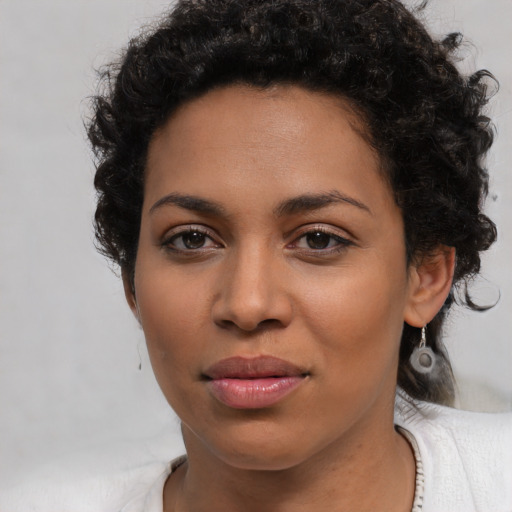 Joyful latino young-adult female with short  brown hair and brown eyes