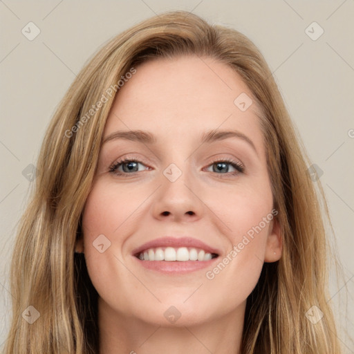 Joyful white young-adult female with long  brown hair and blue eyes