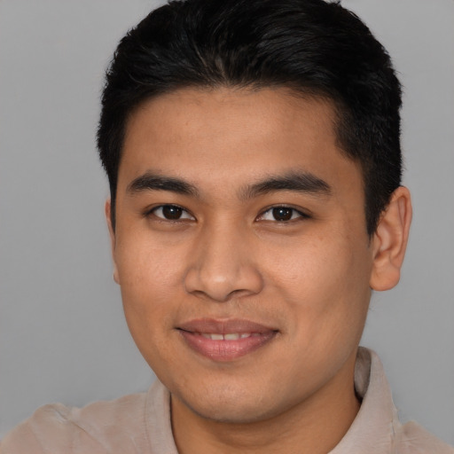 Joyful latino young-adult male with short  brown hair and brown eyes