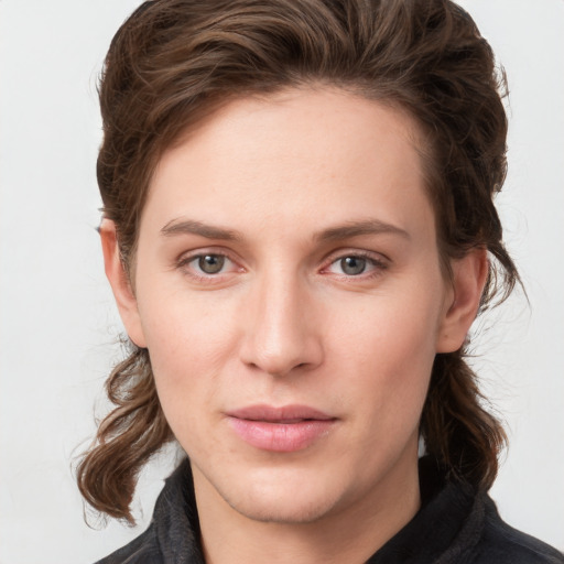 Joyful white young-adult female with medium  brown hair and grey eyes