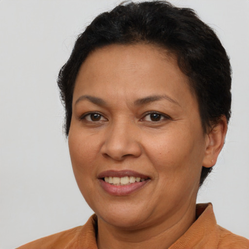 Joyful latino adult female with short  brown hair and brown eyes