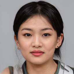 Joyful asian young-adult female with medium  black hair and brown eyes