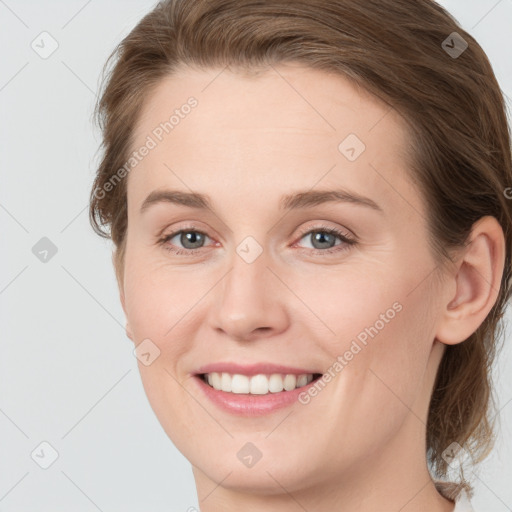 Joyful white young-adult female with medium  brown hair and grey eyes