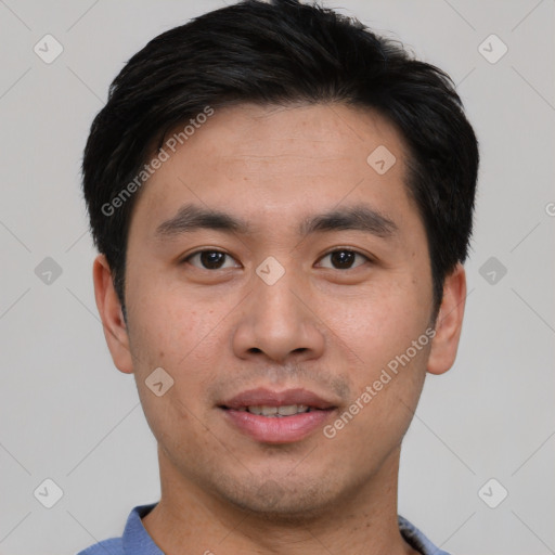 Joyful asian young-adult male with short  black hair and brown eyes