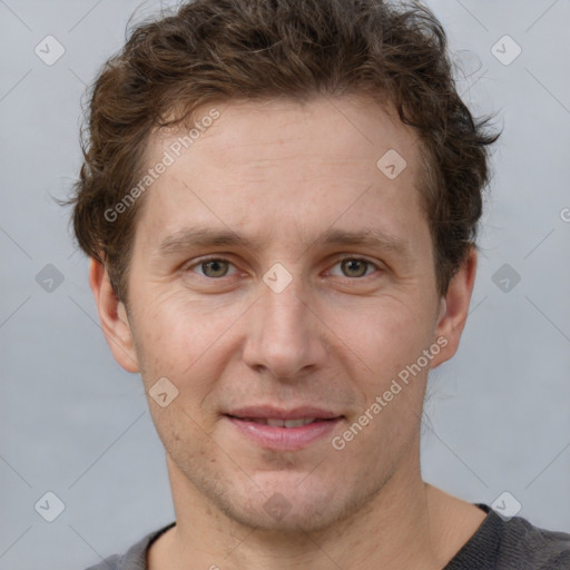 Joyful white adult male with short  brown hair and grey eyes