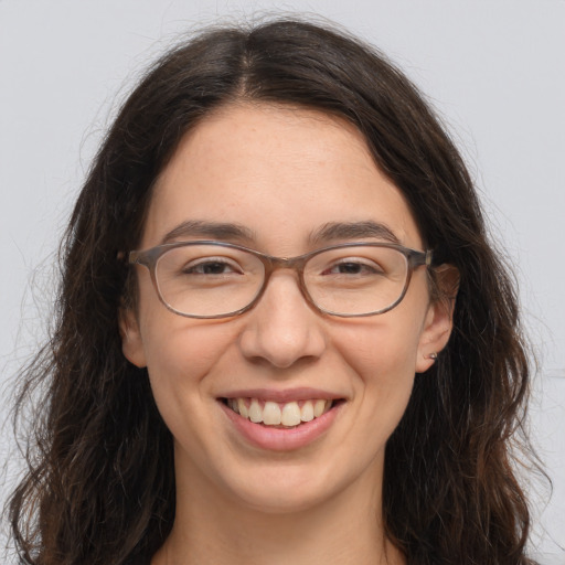 Joyful white adult female with long  brown hair and brown eyes