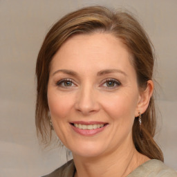 Joyful white adult female with medium  brown hair and grey eyes