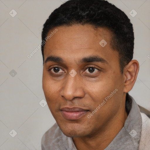 Joyful black young-adult male with short  black hair and brown eyes