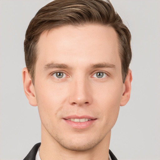 Joyful white young-adult male with short  brown hair and grey eyes