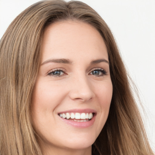 Joyful white young-adult female with long  brown hair and green eyes