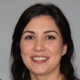 Joyful white adult female with medium  brown hair and brown eyes