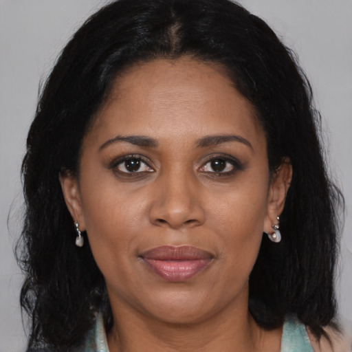 Joyful black adult female with medium  brown hair and brown eyes