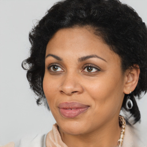 Joyful black young-adult female with medium  brown hair and brown eyes