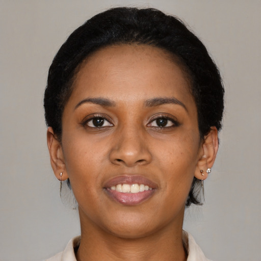 Joyful black young-adult female with short  brown hair and brown eyes