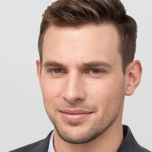 Joyful white young-adult male with short  brown hair and grey eyes