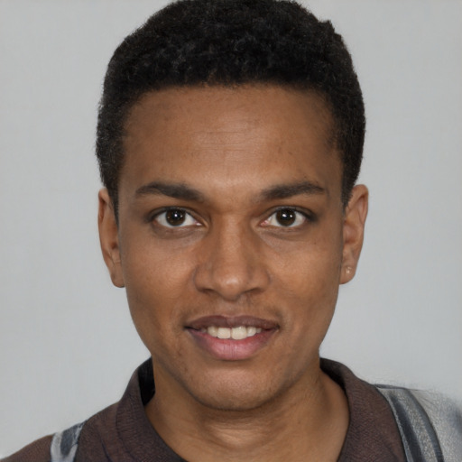 Joyful black young-adult male with short  black hair and brown eyes